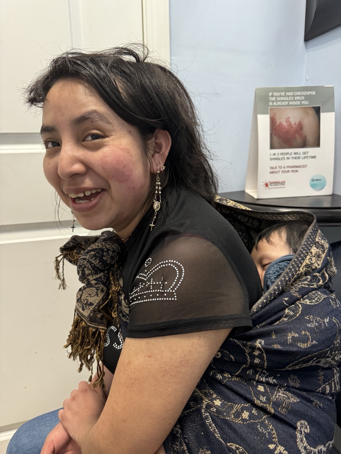 Una persona sonríe sentada en un interior